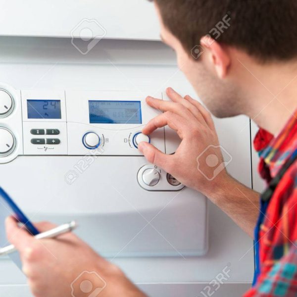 26703867-technician-servicing-the-gas-boiler-for-hot-water-and-heating